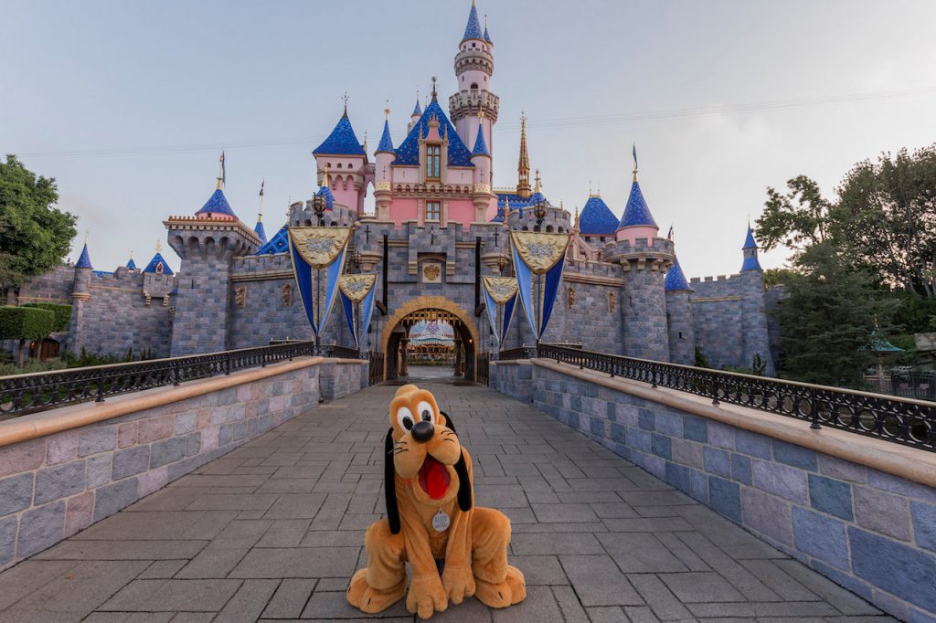 Pluto in front of Sleeping Beauty Castle at Disneyland Resort