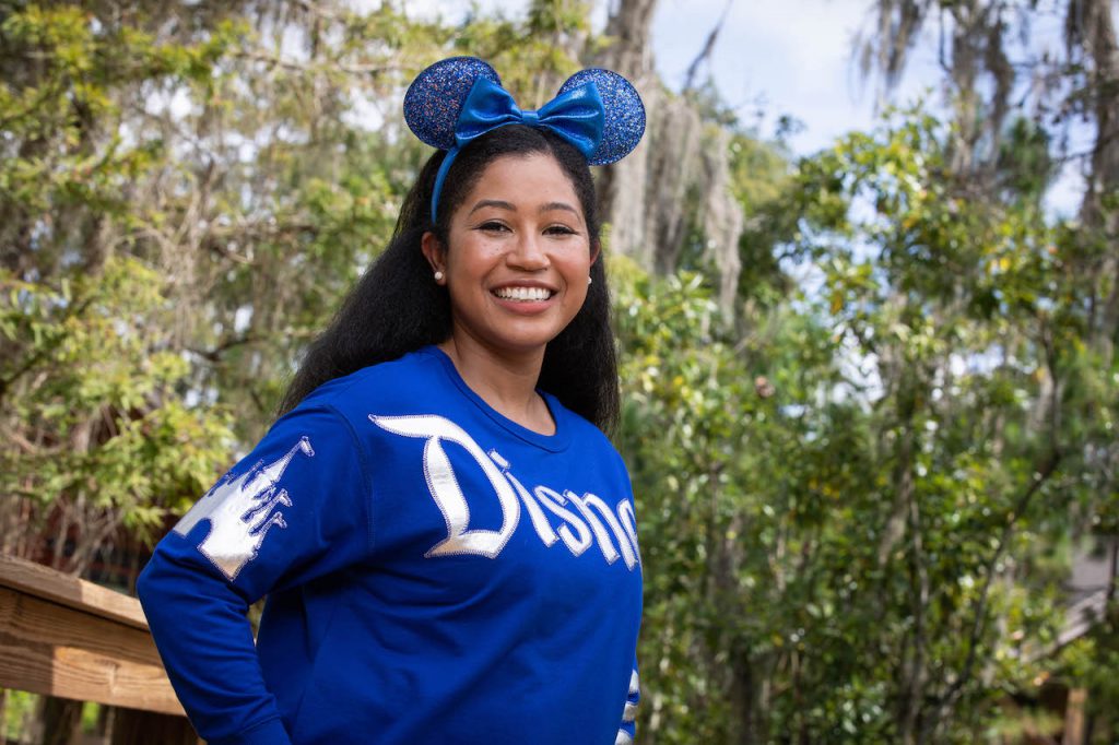 Girl in Wishes Come True Blue Minnie Mouse Ear headband and spirit jersey
